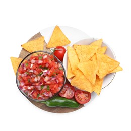 Delicious salsa in bowl, nacho chips and ingredients isolated on white, top view