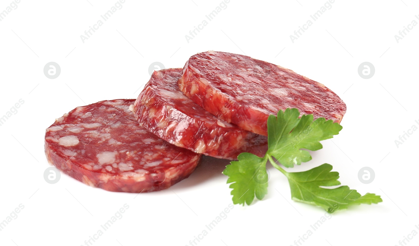 Photo of Pieces of delicious dry cured sausage and parsley isolated on white