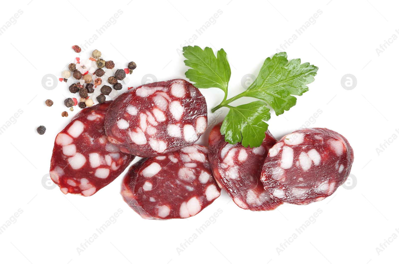 Photo of Pieces of delicious dry cured sausage and spices isolated on white, top view