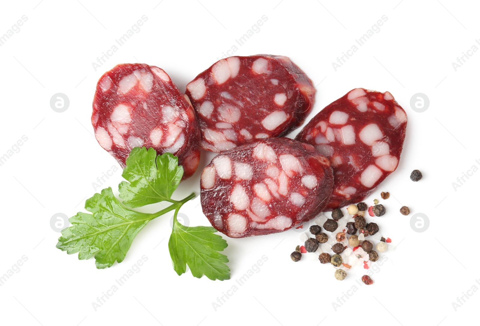 Photo of Pieces of delicious dry cured sausage and spices isolated on white, top view