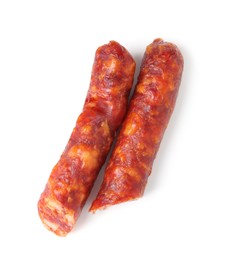 Photo of Pieces of delicious thin dry cured sausage isolated on white, top view