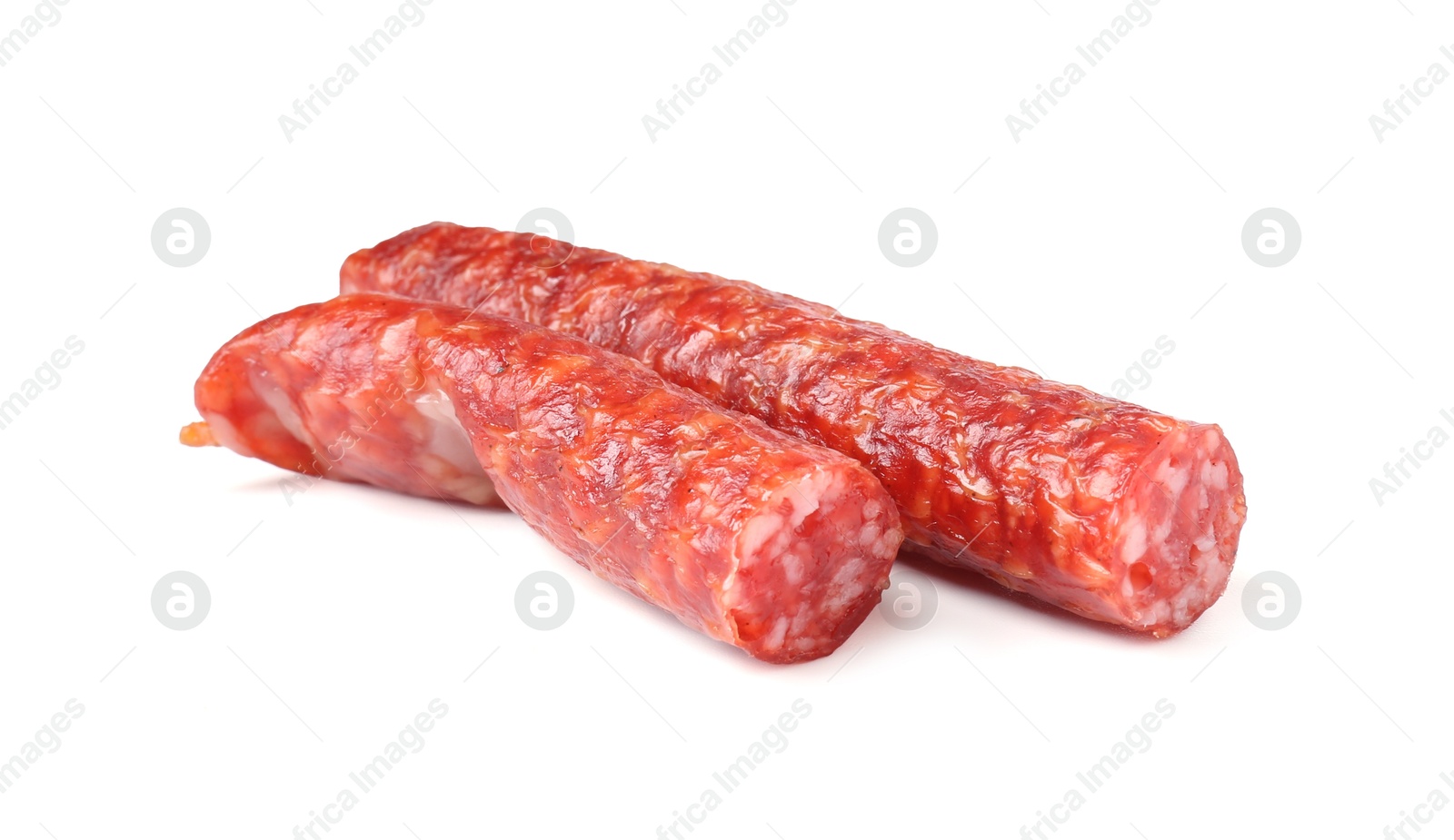 Photo of Delicious thin dry cured sausages isolated on white