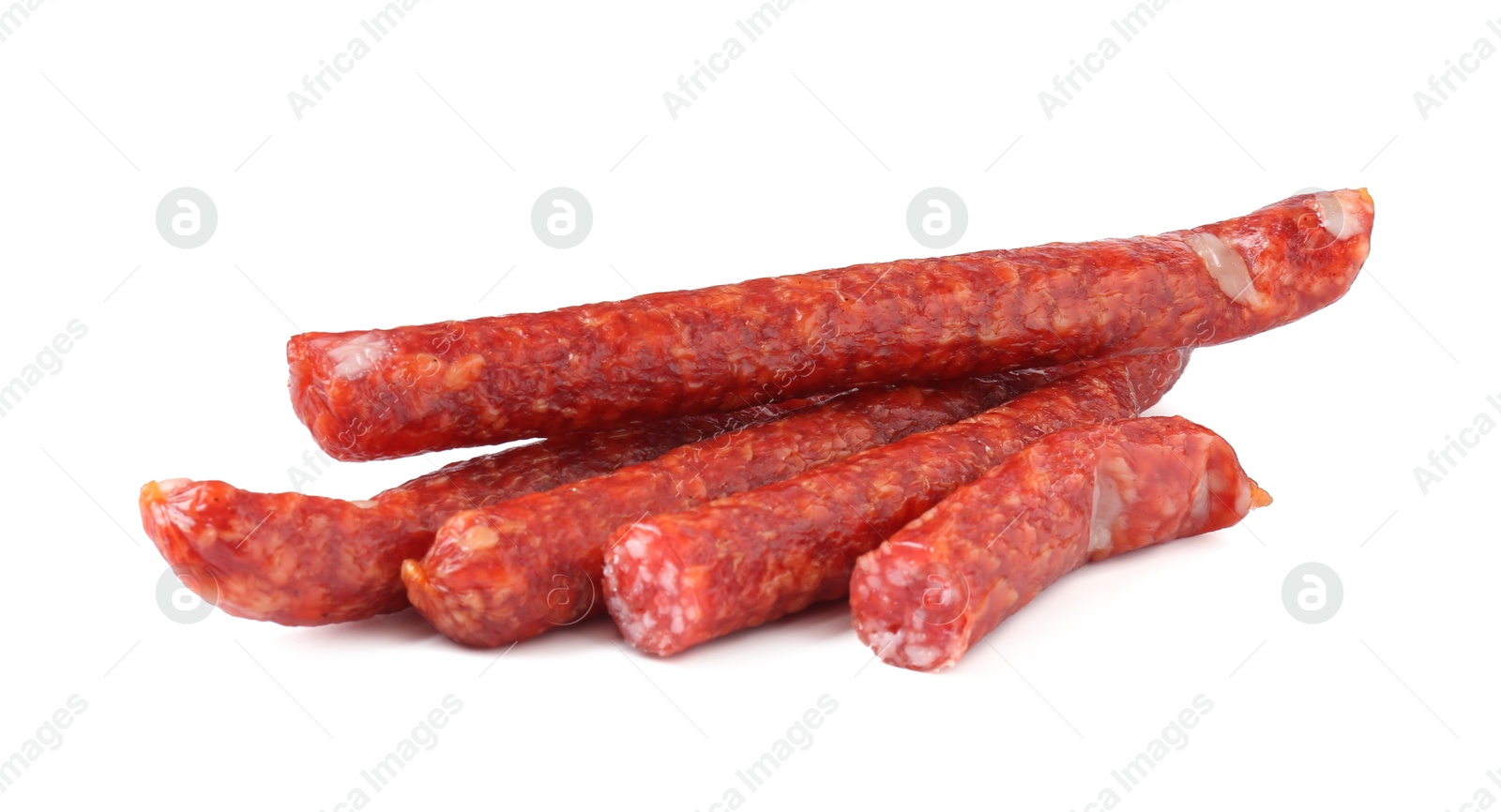 Photo of Delicious thin dry cured sausages isolated on white