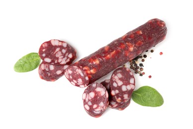 Photo of Delicious dry cured sausage and spices isolated on white, top view