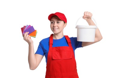 Professional painter with color samples and bucket of paint on white background