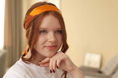 Photo of Teenage girl with stylish bandana indoors, space for text