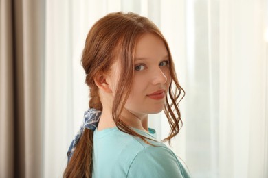 Photo of Teenage girl with long hair and stylish bandana indoors