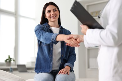 Photo of Doctor and patient shaking hands in clinic