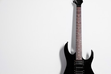 Photo of One modern electric guitar on white background. Space for text