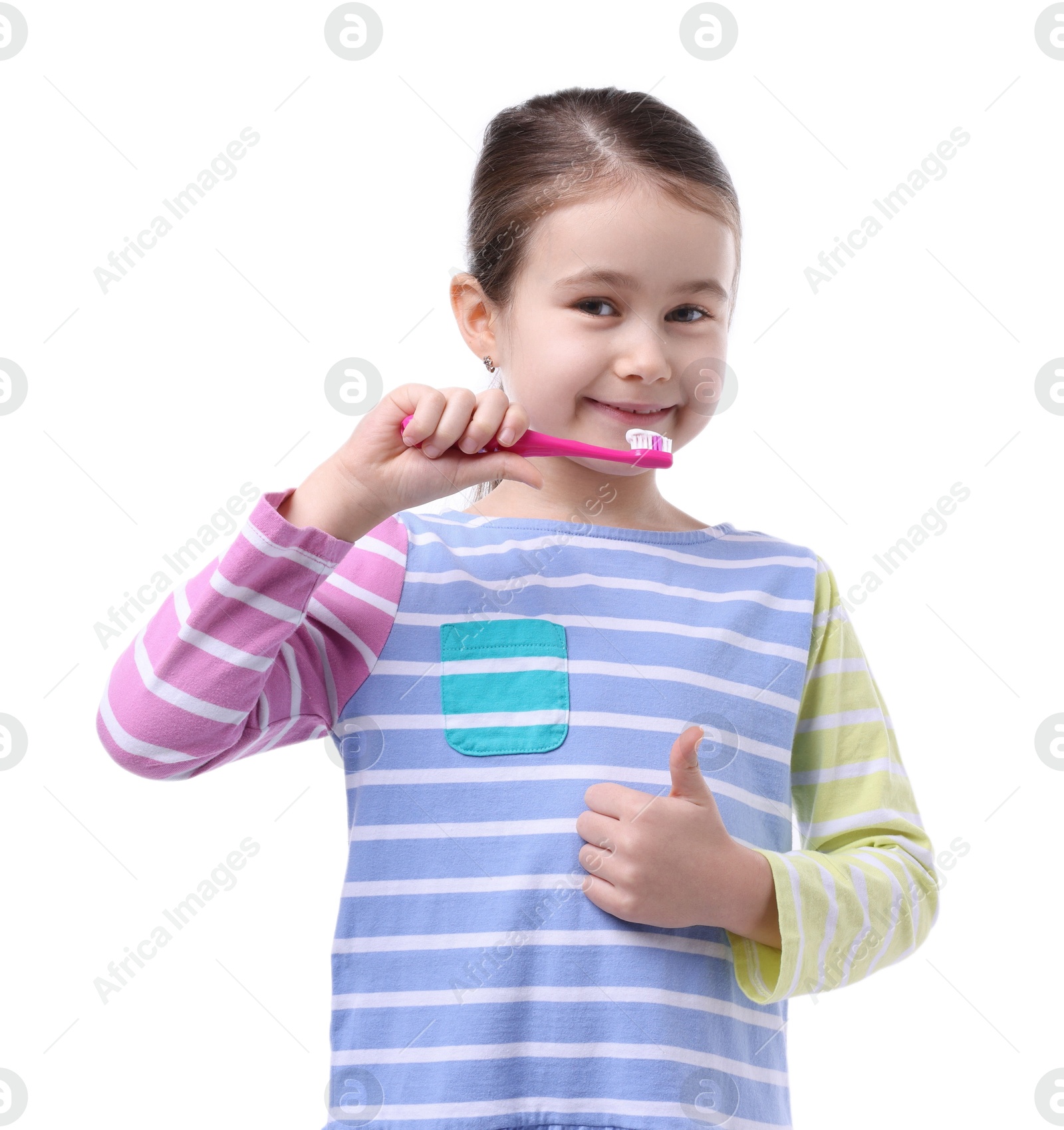 Photo of Cute girl brushing her teeth and showing thumbs up on white background