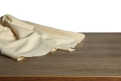 Beige tablecloth on wooden table against white background, closeup