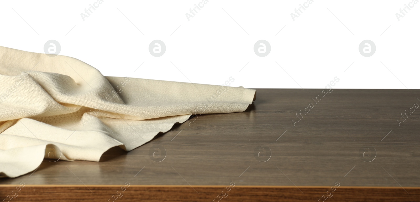 Photo of Beige tablecloth on wooden table against white background