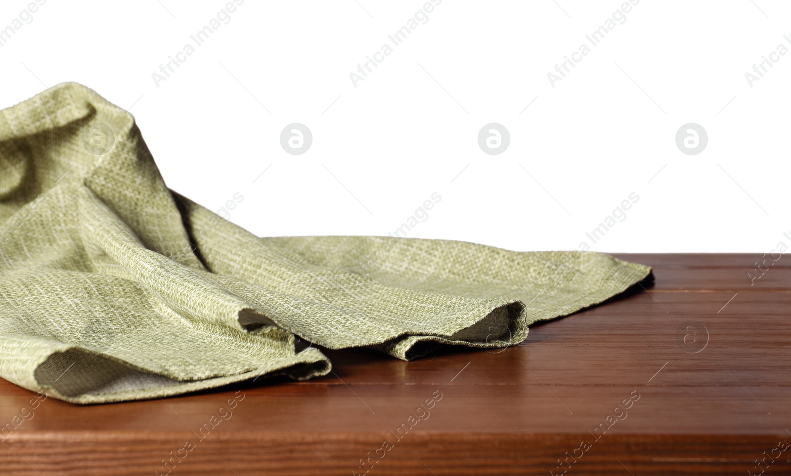 Photo of Green tablecloth on wooden table against white background, closeup