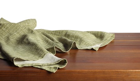 Green tablecloth on wooden table against white background, closeup