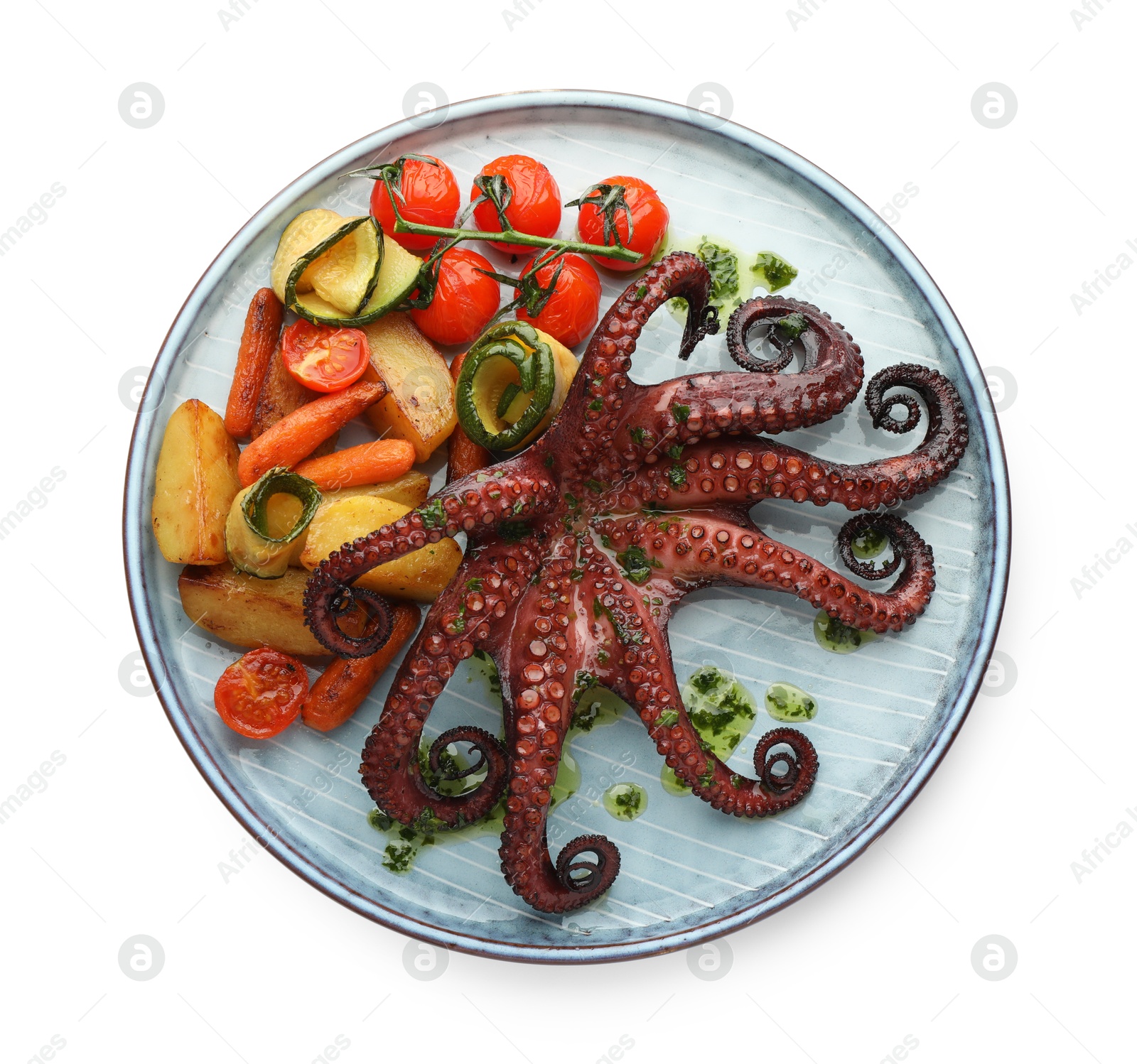 Photo of Fried octopus with herb sauce and vegetables isolated on white, top view