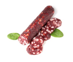 Delicious dry cured sausage and spinach isolated on white, top view