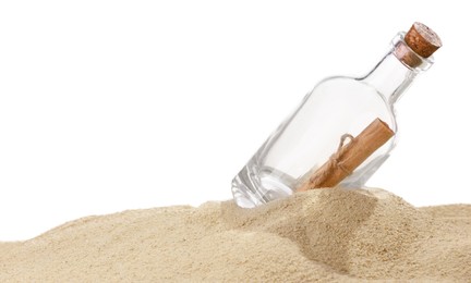 Rolled letter in corked glass bottle on sand against white background