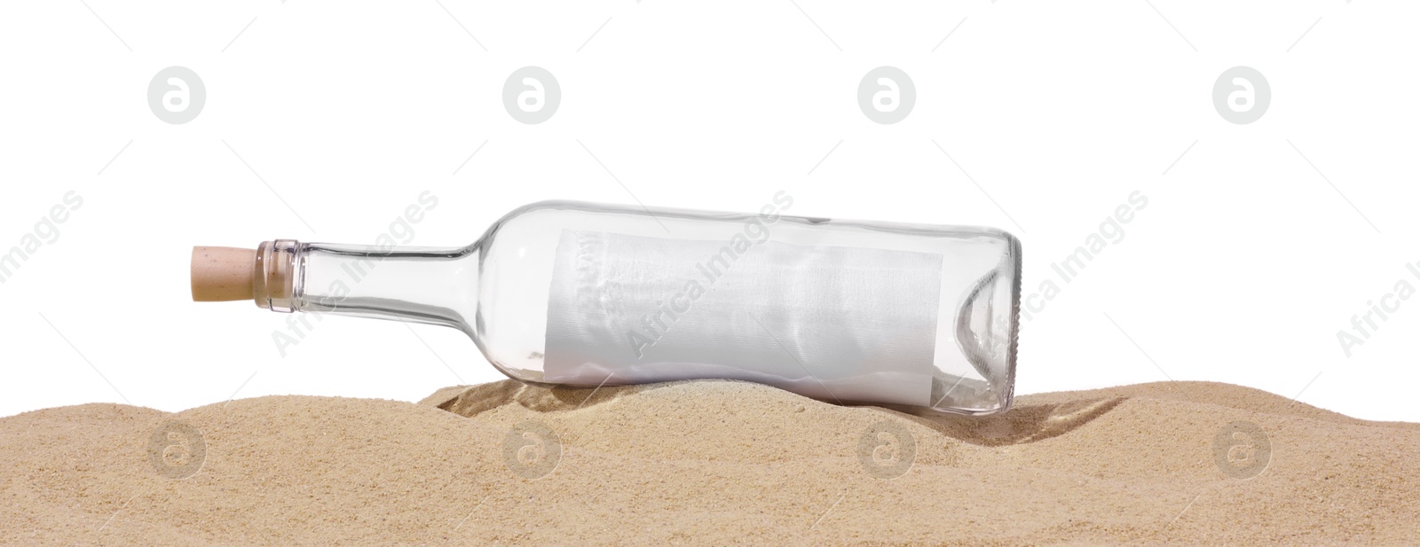 Photo of Rolled letter in corked glass bottle on sand against white background