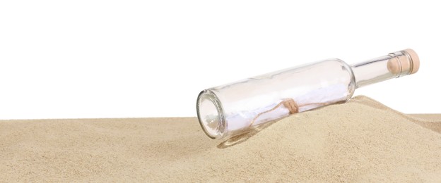 Photo of Rolled letter in corked glass bottle on sand against white background