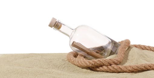 Photo of Rolled letter in corked glass bottle and rope on sand against white background