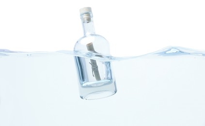 Corked glass bottle with rolled letter in water on white background