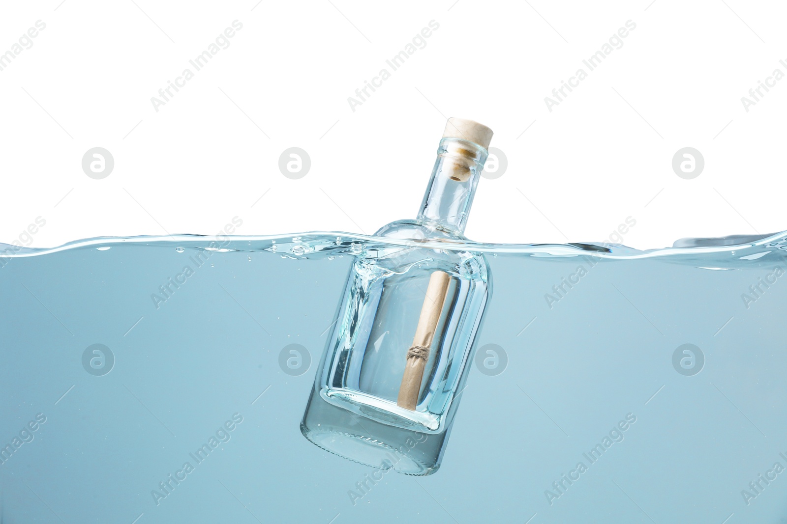 Photo of Corked glass bottle with rolled letter in water on white background