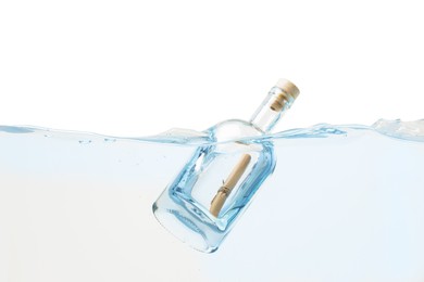 Photo of Corked glass bottle with rolled letter in water on white background