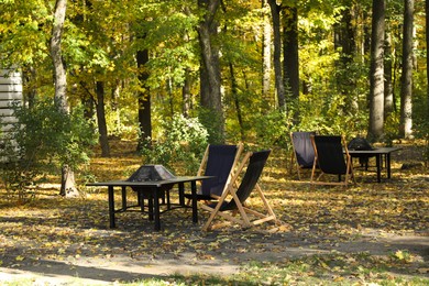 Photo of Picnic table and chairs in beautiful autumnal forest