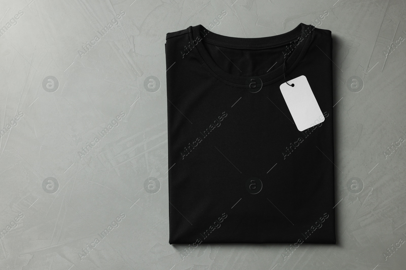 Photo of Blank black t-shirt on grey background, top view. Mockup for design