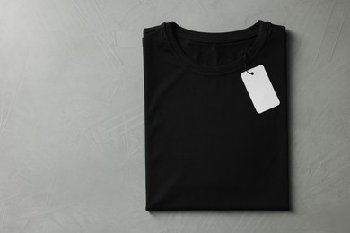 Photo of Blank black t-shirt on grey background, top view. Mockup for design