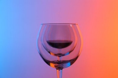 Photo of Wine glasses on color background, closeup view