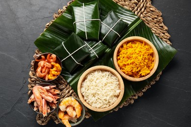 Photo of Cut banana leaves with rice and shrimps on dark table, top view. Healthy eco serving