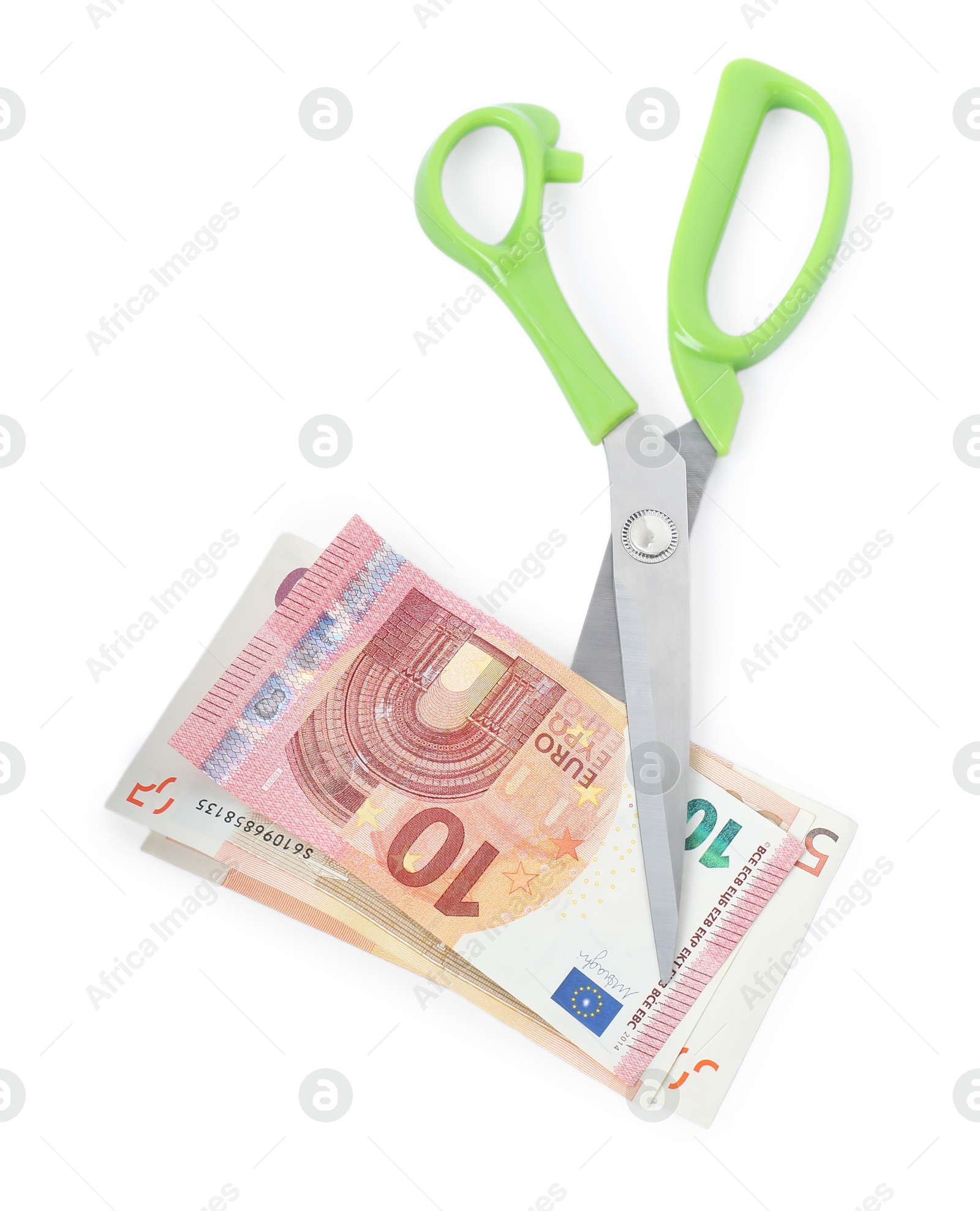 Photo of Euro banknotes and scissors isolated on white, top view