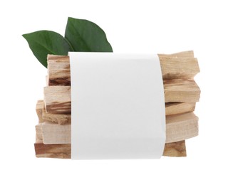 Photo of Palo santo sticks wrapped in paper and green leaves on white background