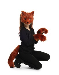 Photo of Quadrobics. Girl wearing fox mask, tail and gloves on white background