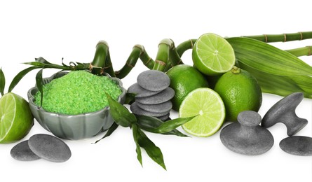 Photo of Spa composition with fresh limes, sea salt, massage stones and bamboo isolated on white