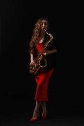 Photo of Professional musician playing saxophone on black background