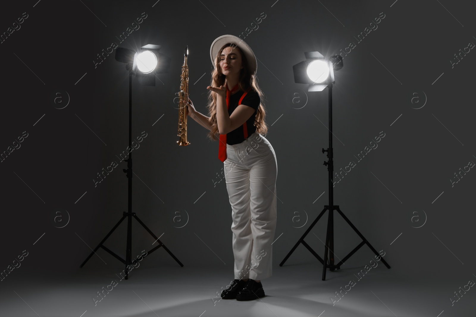 Photo of Musician with soprano saxophone on grey background