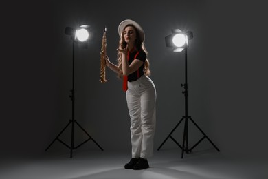 Photo of Musician with soprano saxophone on grey background