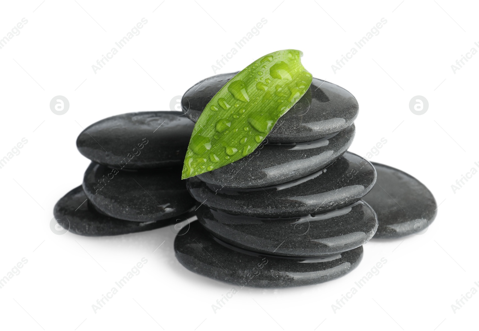 Photo of Wet spa stones with leaf isolated on white