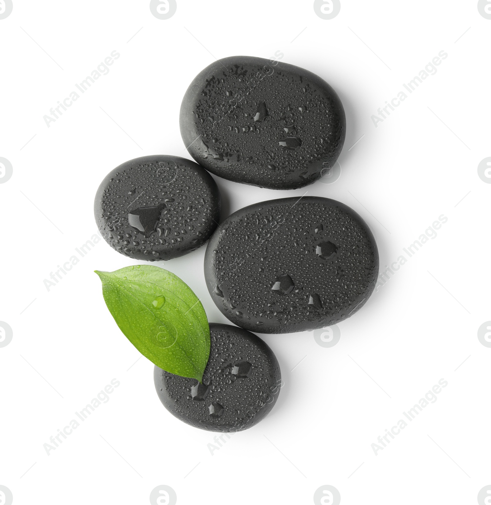 Photo of Wet spa stones and green leaf isolated on white, top view