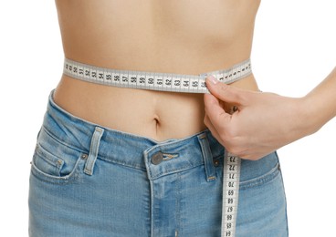 Photo of Woman measuring waist circumference on white background, closeup