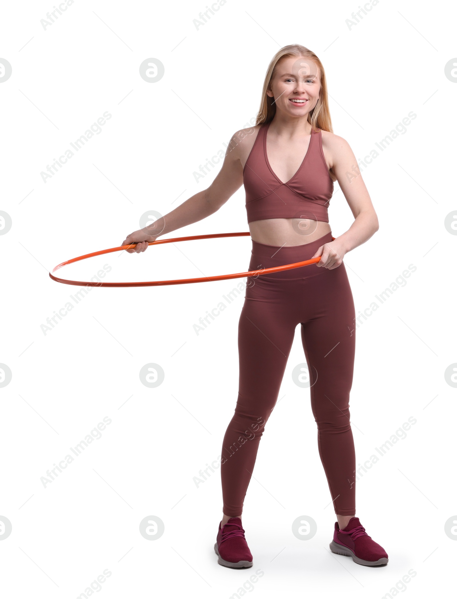 Photo of Beautiful young woman exercising with hula hoop on white background