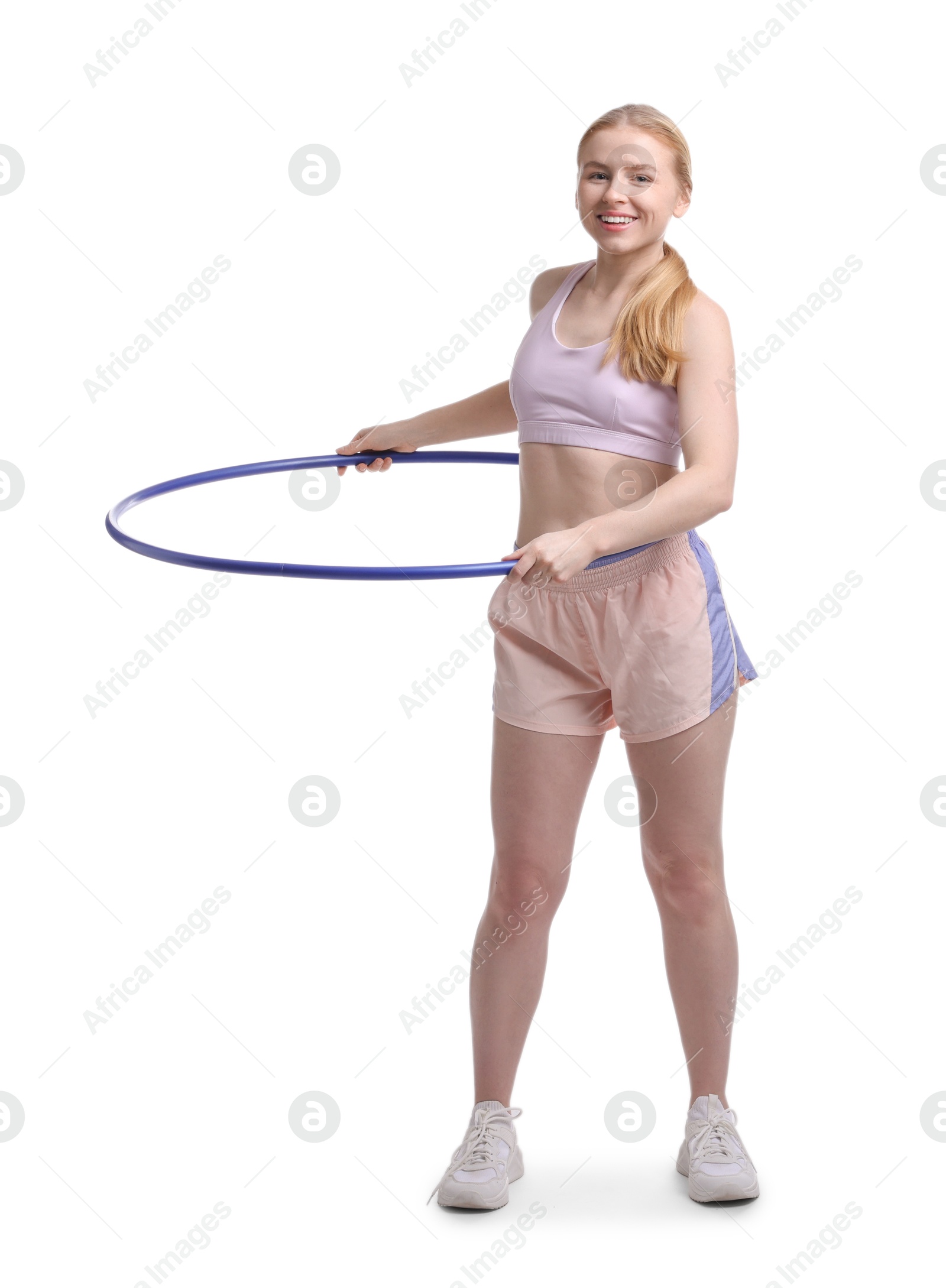 Photo of Beautiful young woman exercising with hula hoop on white background