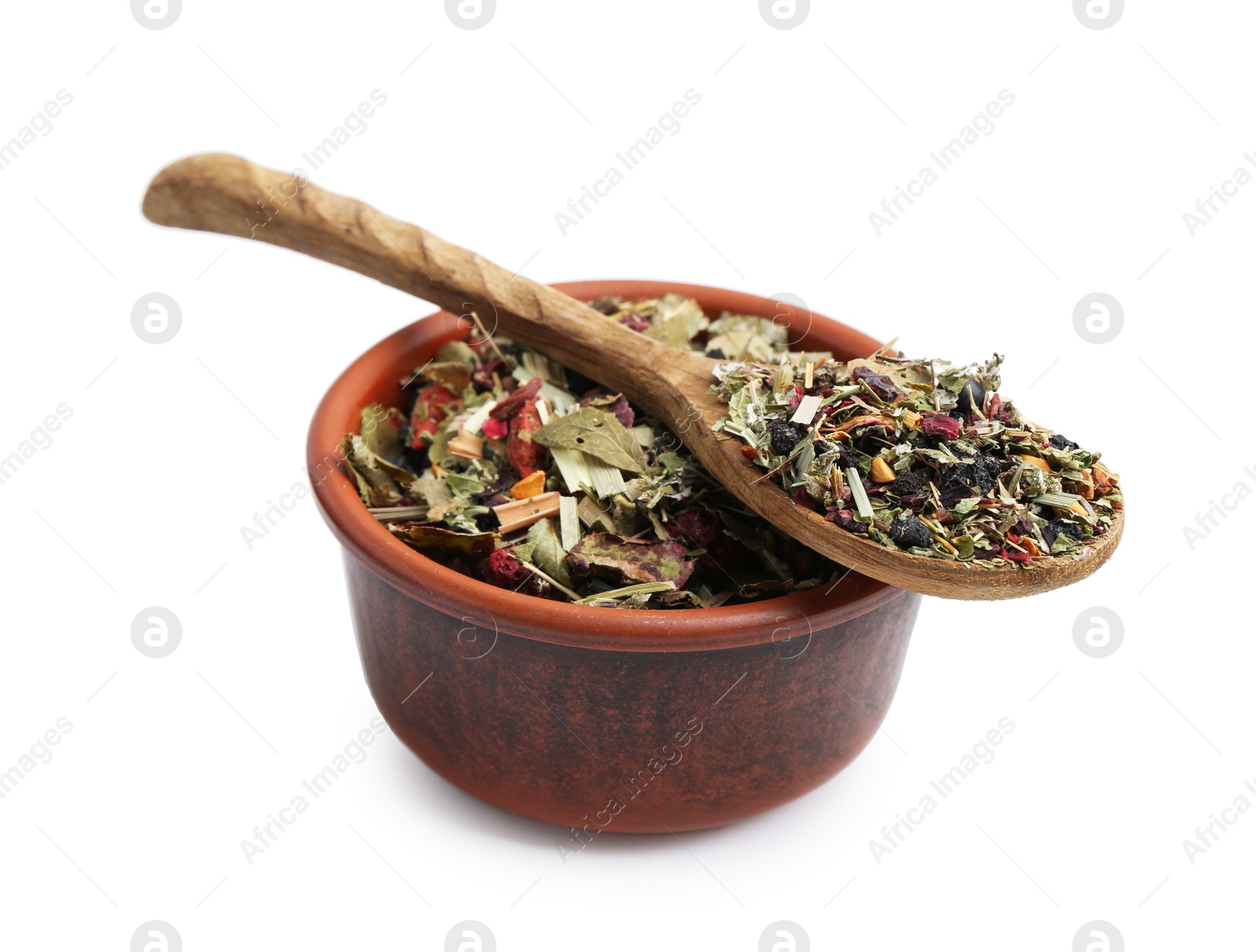 Photo of Dry herbal tea brew in bowl with spoon isolated on white