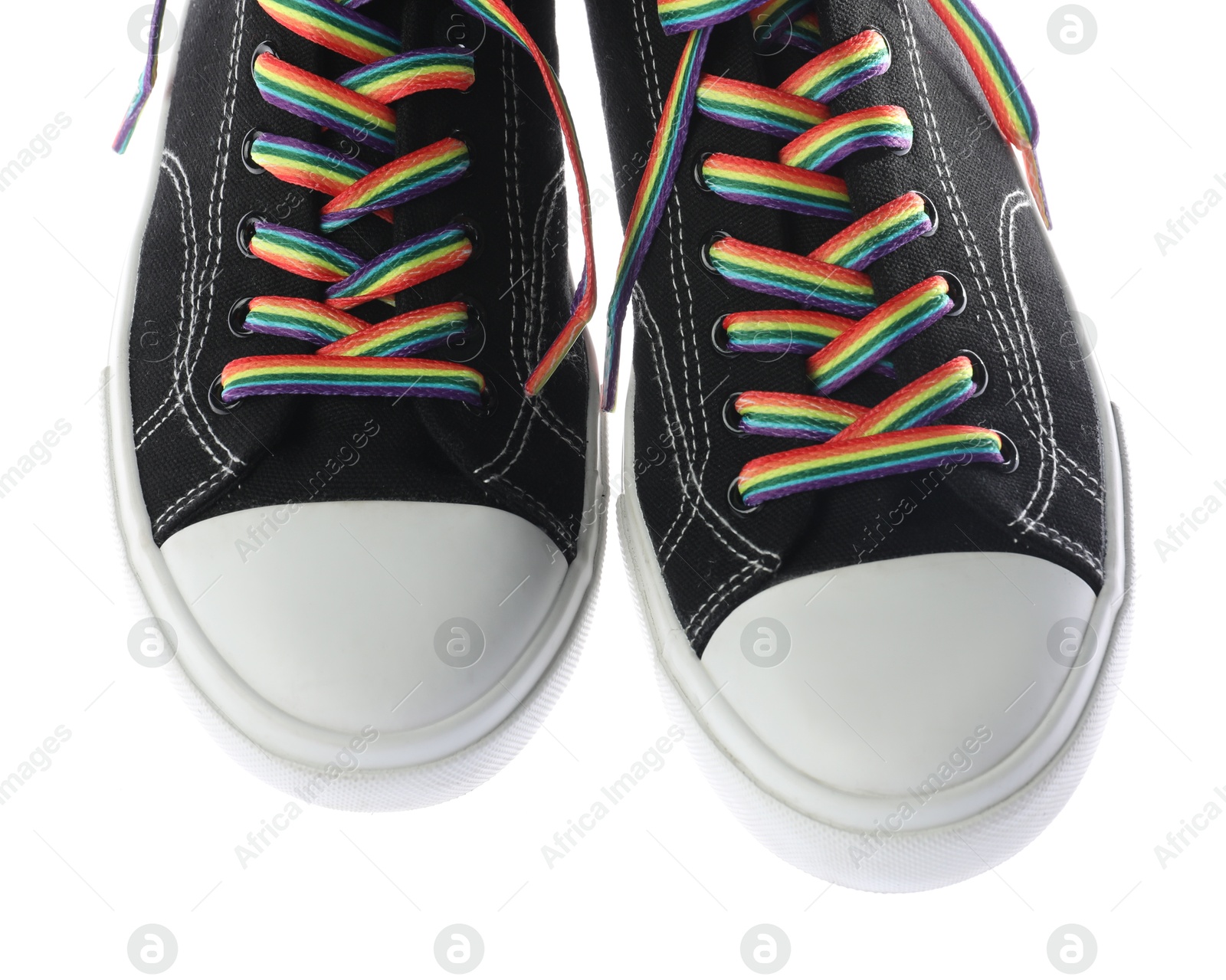 Photo of Black shoes with bright rainbow laces on white background, above view. LGBT concept