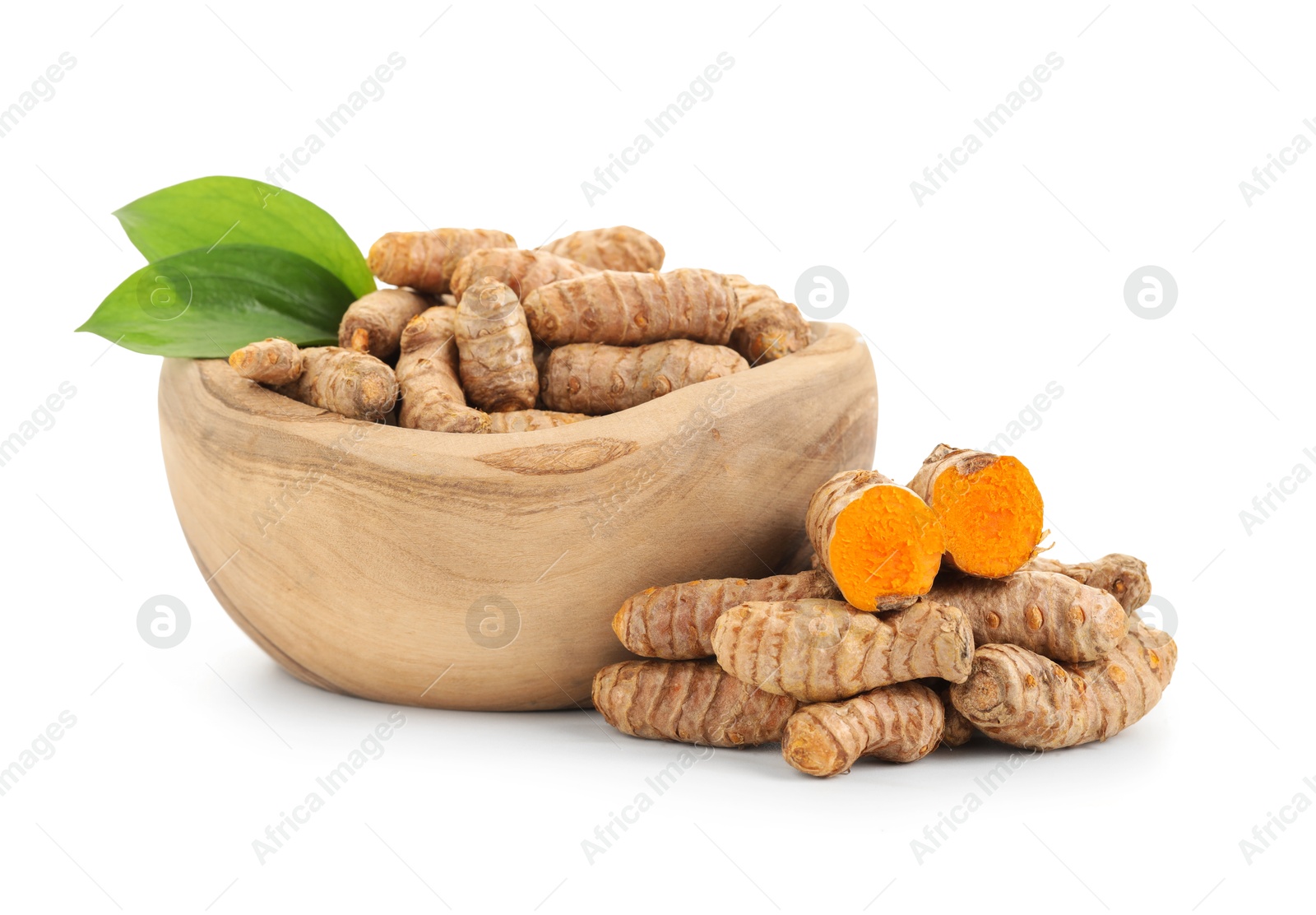 Photo of Raw turmeric roots and green leaves isolated on white