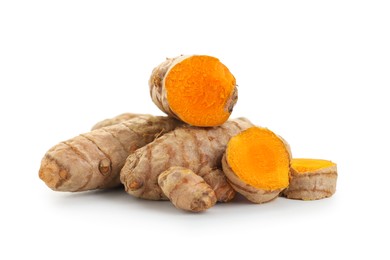 Photo of Whole and cut turmeric roots isolated on white