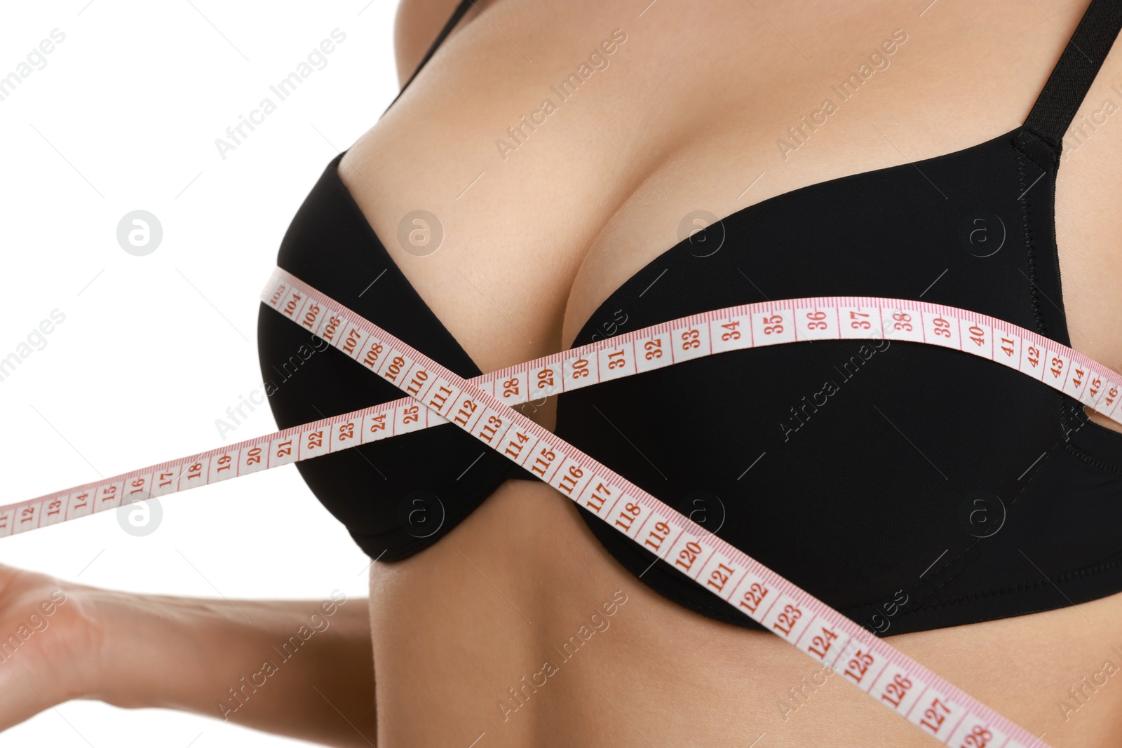 Photo of Woman in beautiful bra measuring breast circumference on white background, closeup