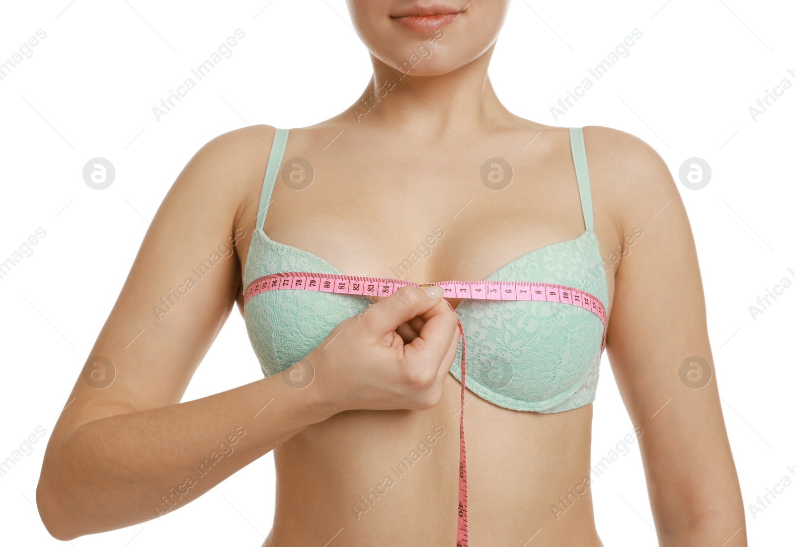 Photo of Woman in beautiful bra measuring breast circumference on white background, closeup